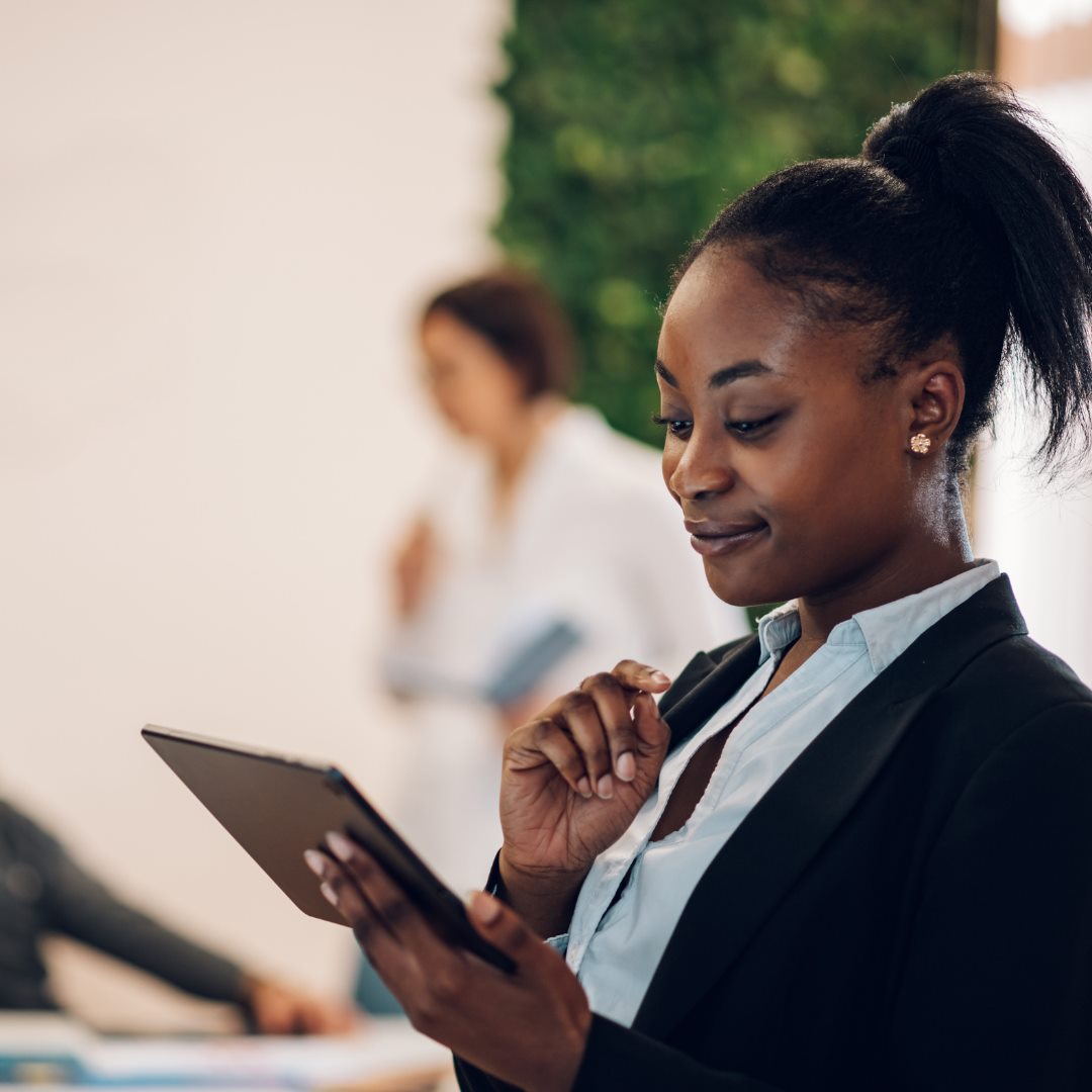 A professional woman holding a tablet